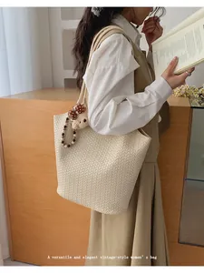 Elegant vintage off-white woven tote bag carried by a model in a lifestyle setting