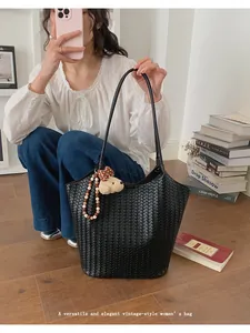 Elegant black woven large capacity tote bag for women with a cute bear charm accessory