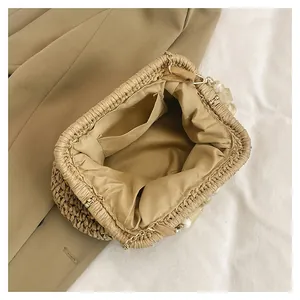Detailed view of French vintage woven straw shell bag showing its lining and pocket
