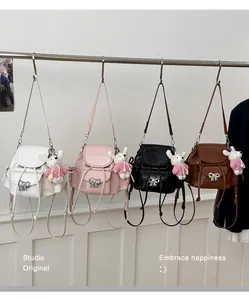 Four versatile mini backpacks in white, pink, black, and brown with cute rabbit charms.