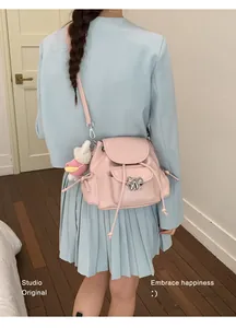 Sweet pink bow backpack detail view styled with blue blazer for a trendy student look