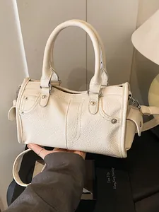 Elegant beige litchi grain leather handbag with top handles and shoulder strap