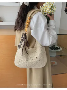Elegant vintage-style cream crochet woven shoulder bag with wooden bead strap and charm