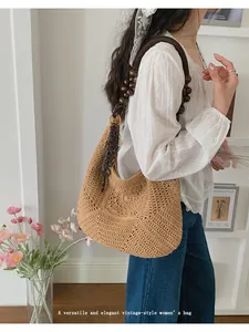 Detailed view of an elegant woven straw bag with vintage wooden beads and shoulder strap.