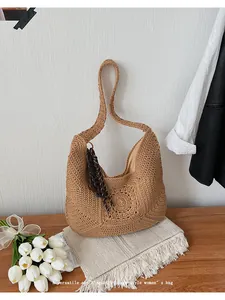 Hand-woven straw shoulder bag with circular hollow pattern for beach vacation
