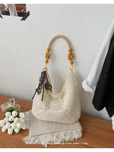Detailed view of a vintage beige crochet shoulder bag with elegant wooden bead handles.