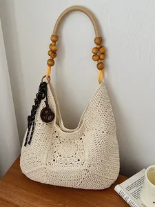 Large hollow out woven straw bag with wooden bead handle for summer beach vacation