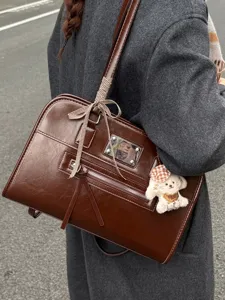 Brown faux leather commuter tote bag with ribbon and dog charm