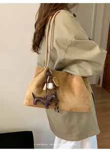 Detailed view of casual retro brown suede tote bag featuring a cute dachshund charm