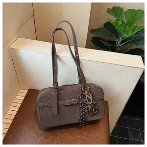 Macro detail of retro distressed gray underarm bag featuring decorative gold buckle straps