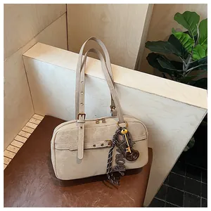 Retro beige underarm shoulder bag with a textured finish and decorative keychain