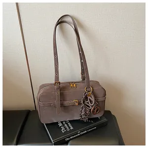 Retro taupe underarm shoulder bag with textured leather and gold-tone buckle detailing.