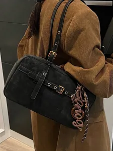 Elegant black suede underarm shoulder bag with gold hardware and chic Bonjour charm