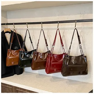Vintage large capacity tote bags in five elegant colors hanging on a metal rack.