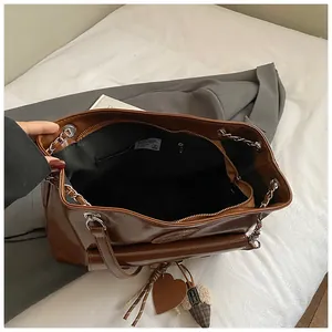 Interior detail of large brown vintage tote bag with black lining and secure zipper