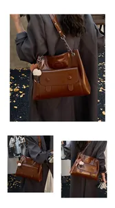 Detailed view of large retro brown tote bag with ice cream charm in autumn setting