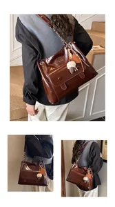 Close-up details of a stylish brown retro tote bag featuring a decorative chain strap.