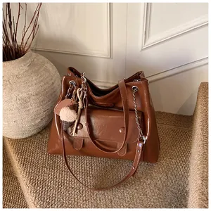 Large capacity brown vintage tote bag in glossy leather with decorative charm