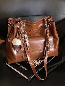 Elegant large capacity retro brown leather tote bag with chain strap and plush charm