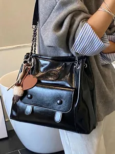Stylish large black glossy vintage commuter tote bag with chain strap and front pocket detail