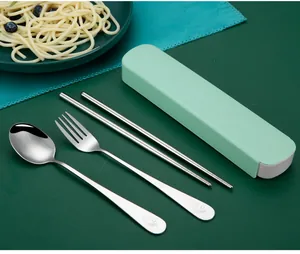 Stainless steel portable cutlery set with fork, spoon, and chopsticks in a green case