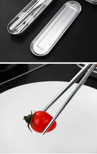 Close-up of stainless steel chopsticks and a portable metal storage case for cutlery