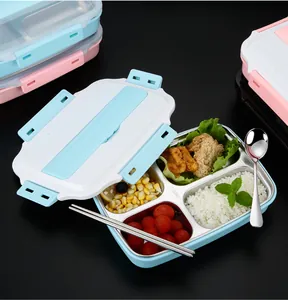 Detailed view of a 4-compartment 304 stainless steel bento lunch box with food and cutlery