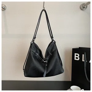 Detailed view of a black pleated tote bag showing the textured fabric and strap design.