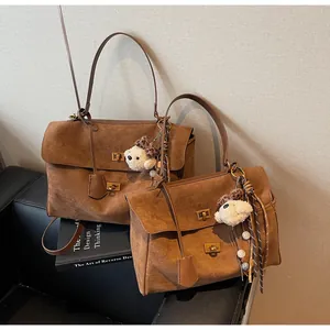 Vintage brown suede commuter handbags in two sizes featuring cute bear bag charms