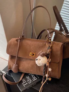 Vintage brown suede crossbody bag with turn-lock and cute dog charm for women