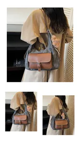 Detail view of a stylish grey fabric tote bag with brown leather pocket and bear charm