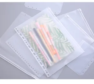 Detail view of transparent binder zipper pouch with pens and notebook inside