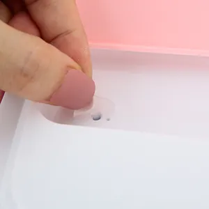Detail shot of the silicone vent plug on a divided stainless steel bento box lid