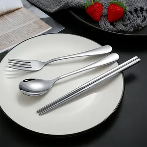 304 stainless steel flatware set with spoon, fork, and chopsticks on a white plate