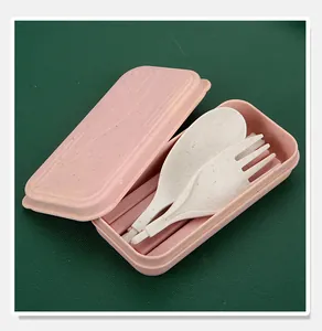 Close-up of wheat straw cutlery set including spoon and fork in a pink travel case