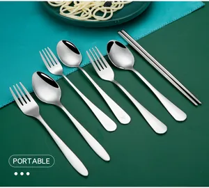 Polished stainless steel cutlery set featuring engraved smiley face detail on handles