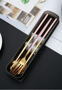 Close-up of a pink and gold stainless steel cutlery set in a black portable case