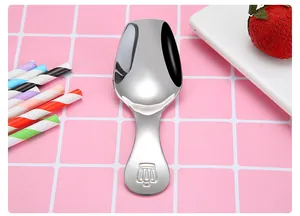 Close-up macro view of a 304 stainless steel tea scoop with crown embossed handle