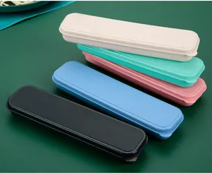 Five colorful portable cutlery storage boxes arranged on a dark green background