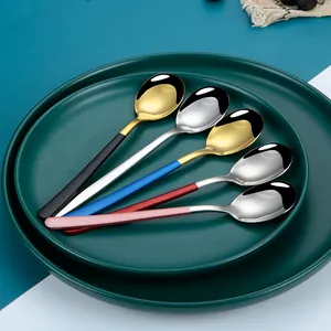 Set of 5 colorful handled 304 stainless steel spoons displayed on dark green plates
