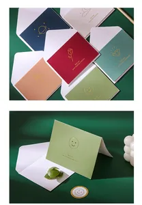 Detailed view of colorful gold foil greeting cards with matching white envelopes.