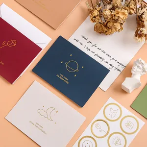 Elegant gold foil greeting cards featuring minimalist planet and moon designs