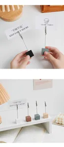 Close-up of minimalist wooden cube card holders in various colors for desktop decoration