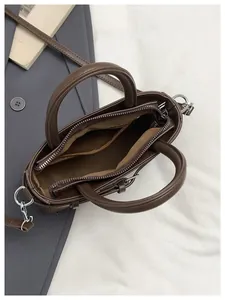 Top-down detail showing the spacious interior and brown lining of the vintage handbag