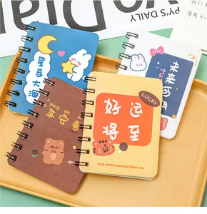 Set of four cute A7 mini coil notebooks featuring cartoon animal designs on a yellow tray