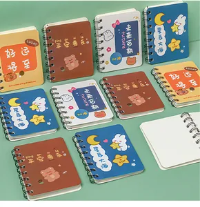 Close-up of cute mini A7 spiral notebooks with cartoon covers and blank inner pages