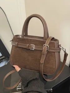 Stylish vintage brown women's bucket handbag with suede detail and adjustable shoulder strap