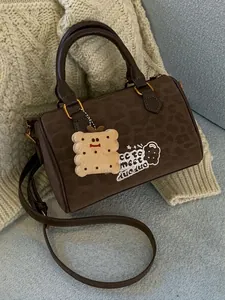 Vintage brown suede Boston handbag with leopard print pattern and cute cookie charm.