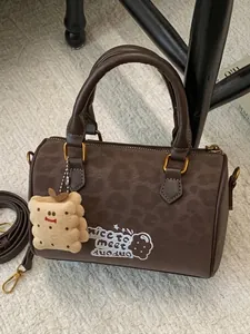 Vintage brown suede Boston bag with cute cookie charm and unique embroidery detail