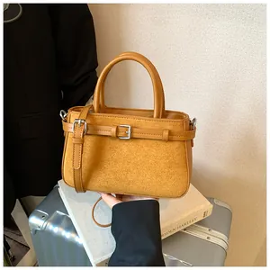Retro suede crossbody bag for women with elegant buckle detail and leather top handles
